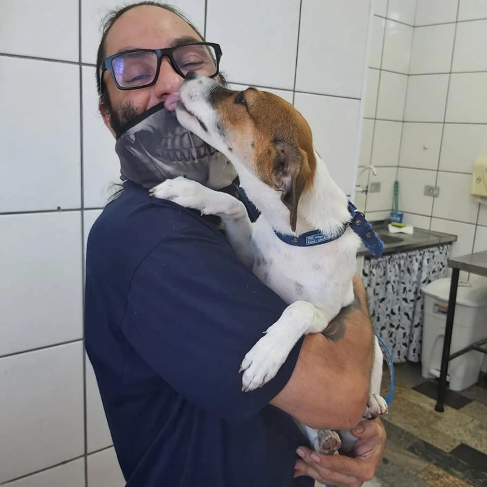 Dr. Saulo em momento de cuidado e carinho com um cachorro na clínica veterinária